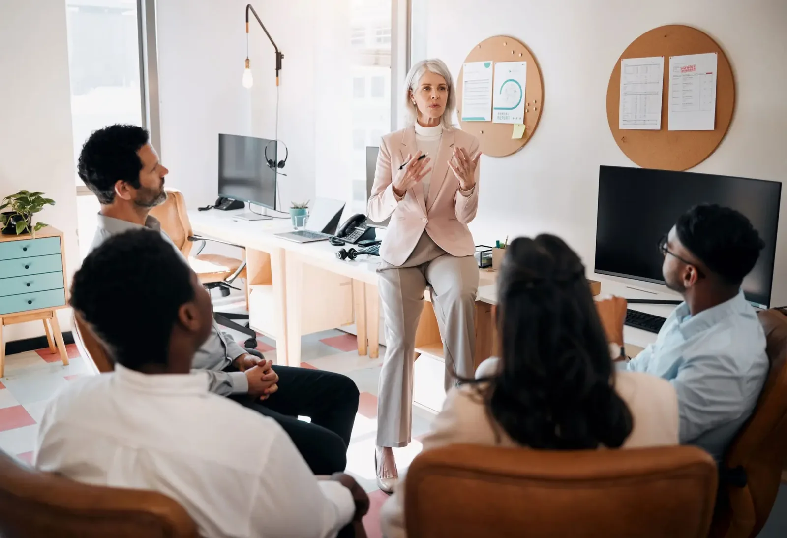 Sales professional presenting B2B buyer journey analytics to team in modern office setting