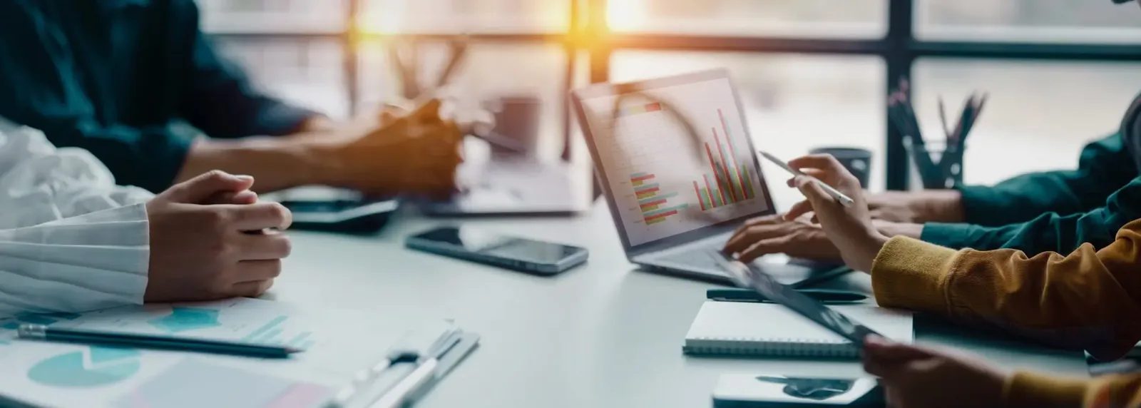 Private equity professionals analyzing financial charts and data during strategic business meeting